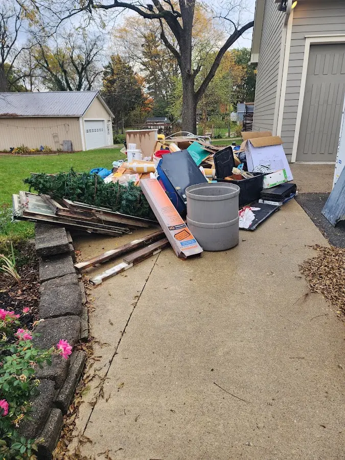 Dumpster being loaded with debris for 3 Yard Dumpster Rental in Boxford